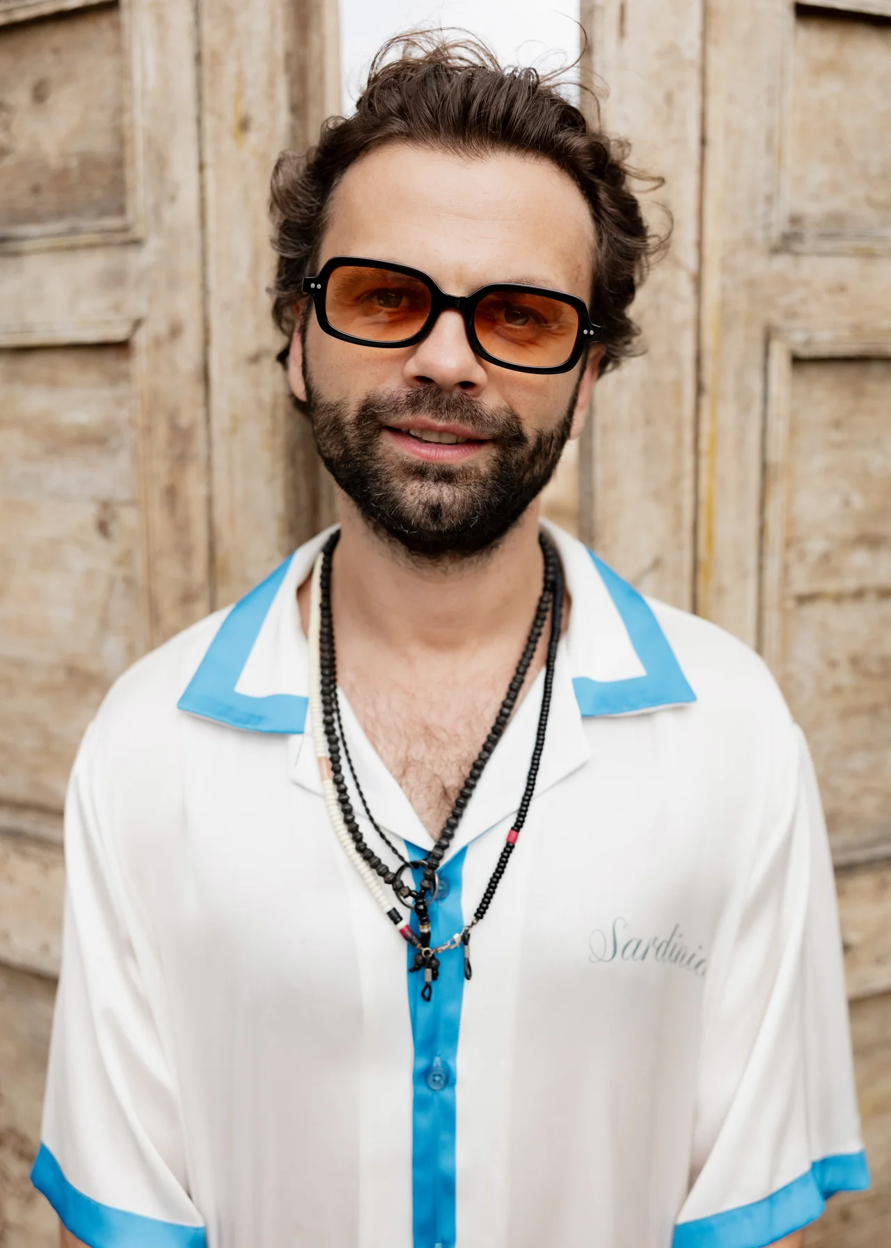 Prohor in amber glasses and a blue-and-white patterned shirt