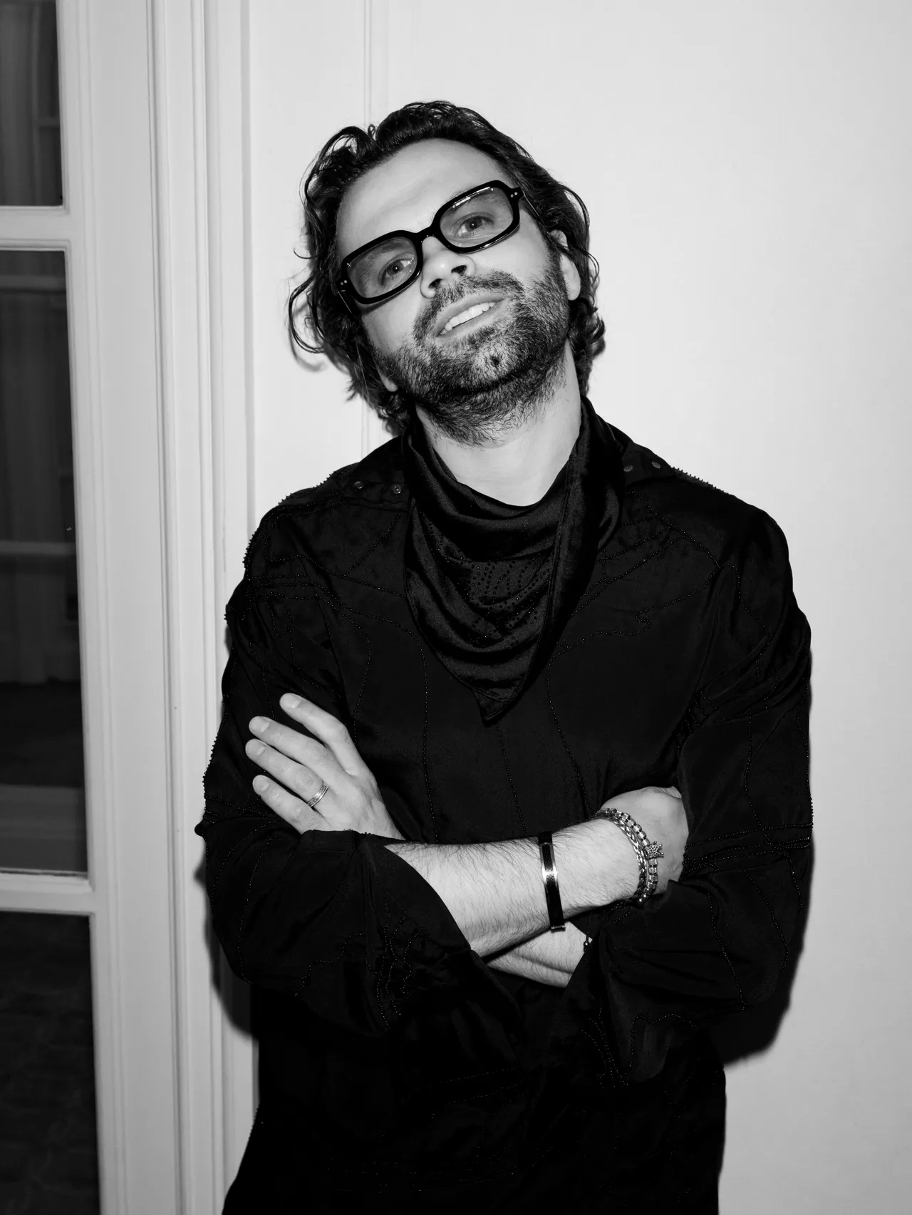 Prohor in the studio, wearing glasses and a black jacket