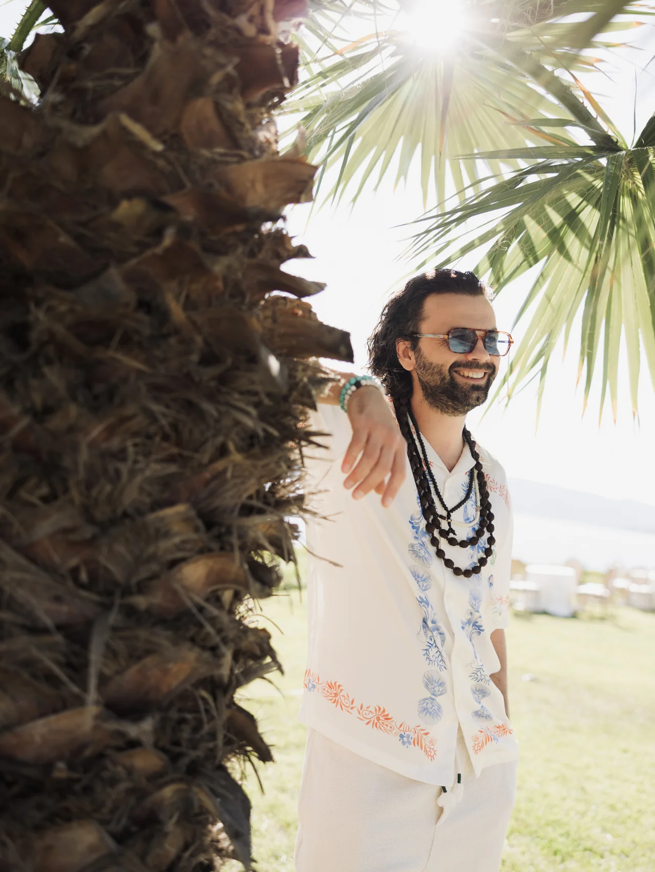 Prohor enjoying the sunshine beside a palm tree