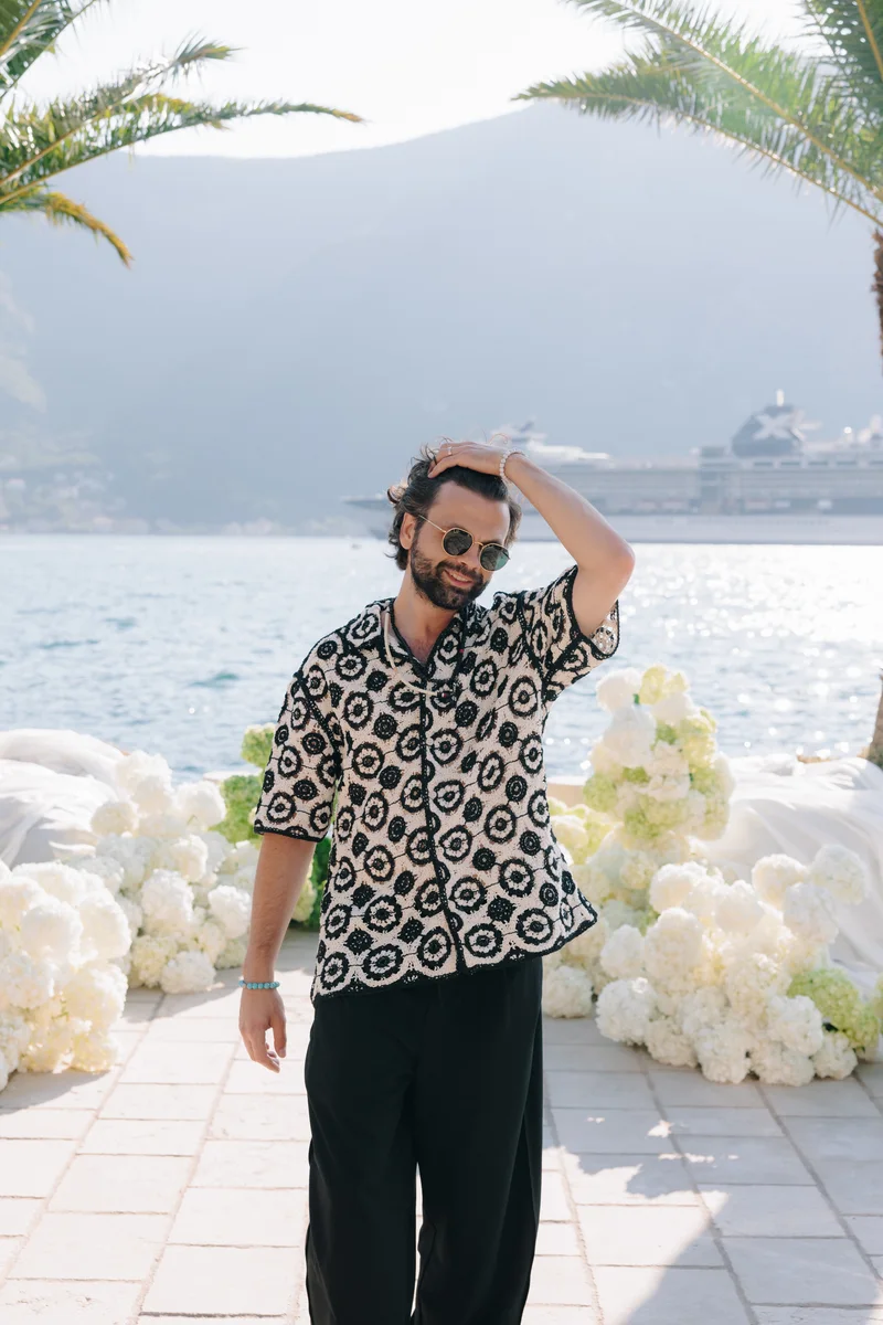 Prohor in a patterned shirt beside the lake at a wedding venue